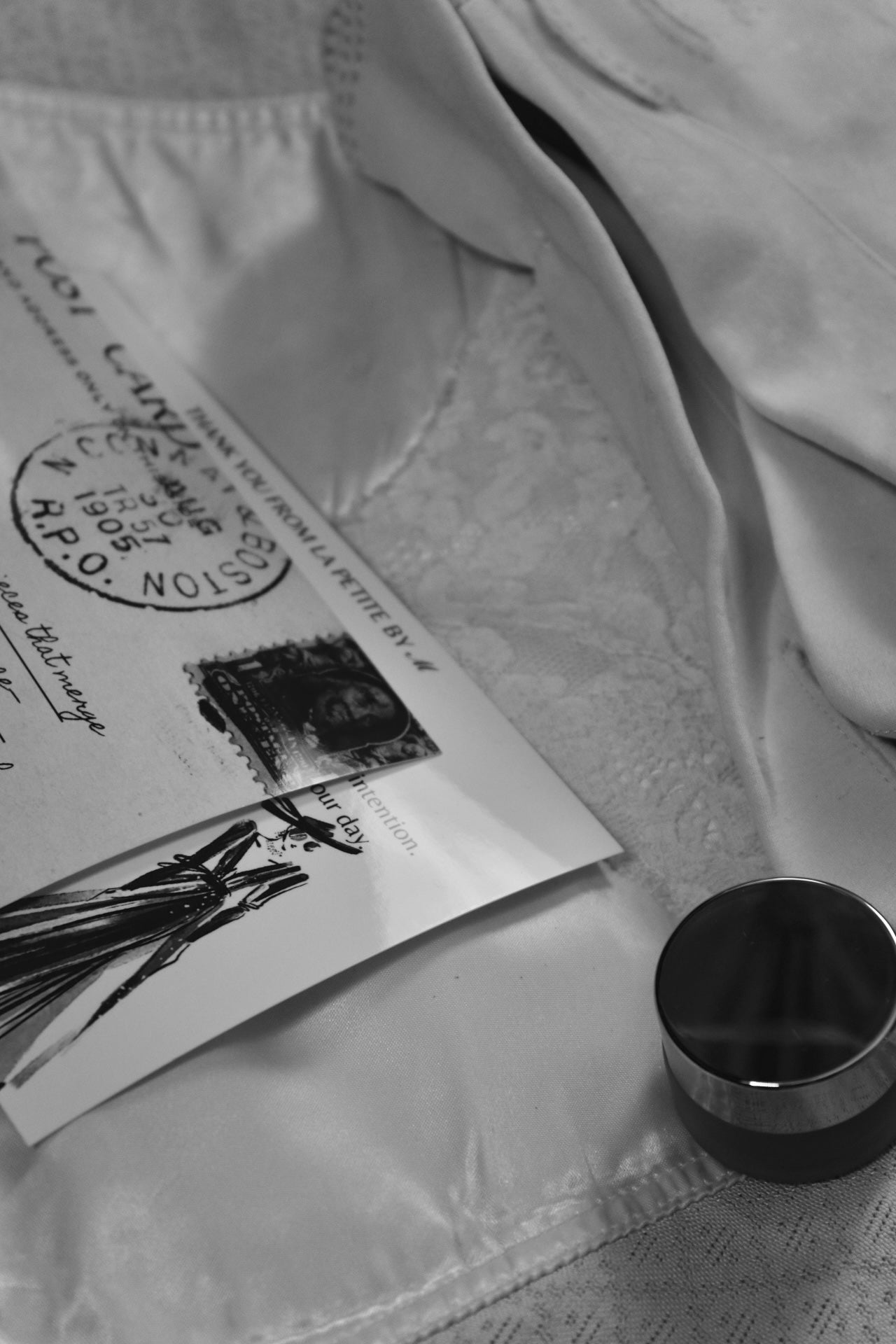 Close-up of a letter with stamps and a pen on a textured surface